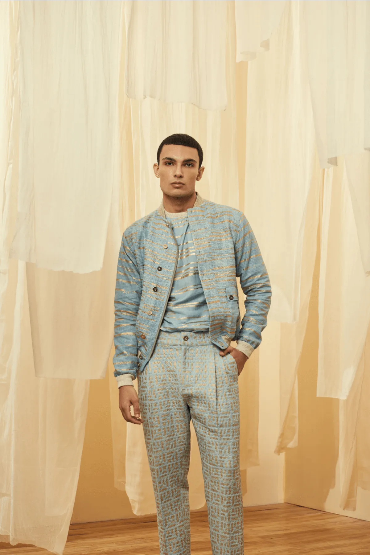 Blue Bomber Jacket with a Blue Poloneck and Blue Trousers